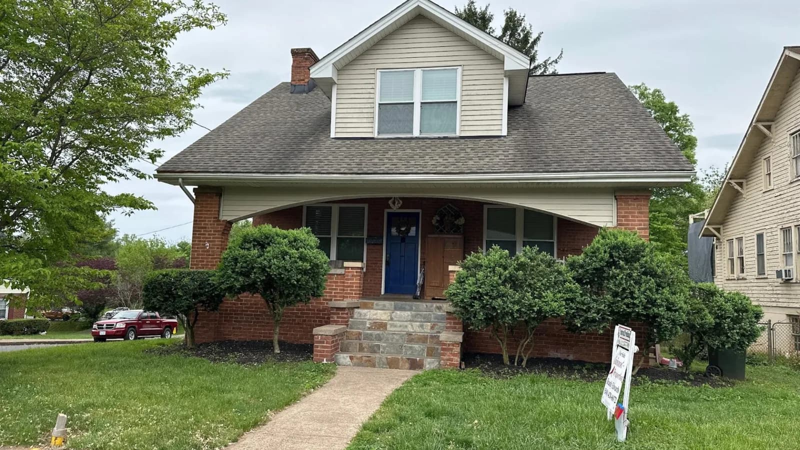 Older ranch-style bungalow home exterior front view