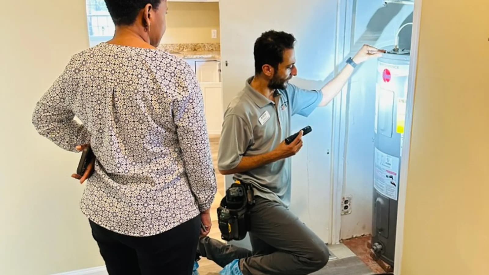 Home inspector examining electrical panel or appliance