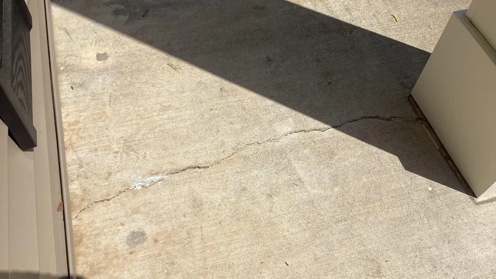 Cracked concrete sidewalk or driveway