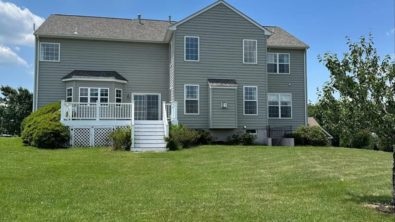 Colonial style home exterior with green lawn